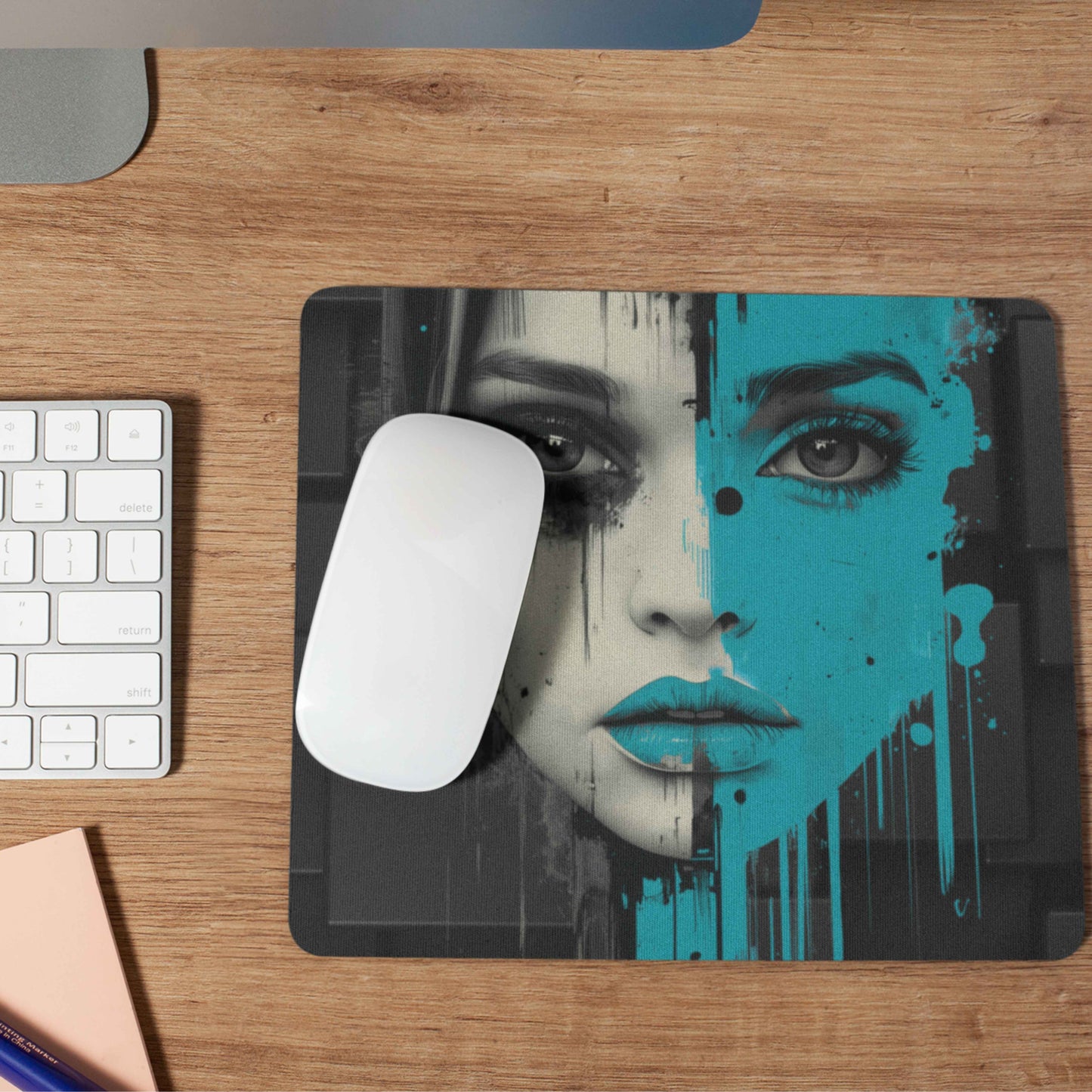 Every power move deserves the perfect foundation—our urban-chic themed mouse pad offers unbeatable grip, designed to keep up with your hustle. This mouse pad features a striking design of a woman's face, with one half in bold, vibrant teal, framed by a black futuristic themed pattern.