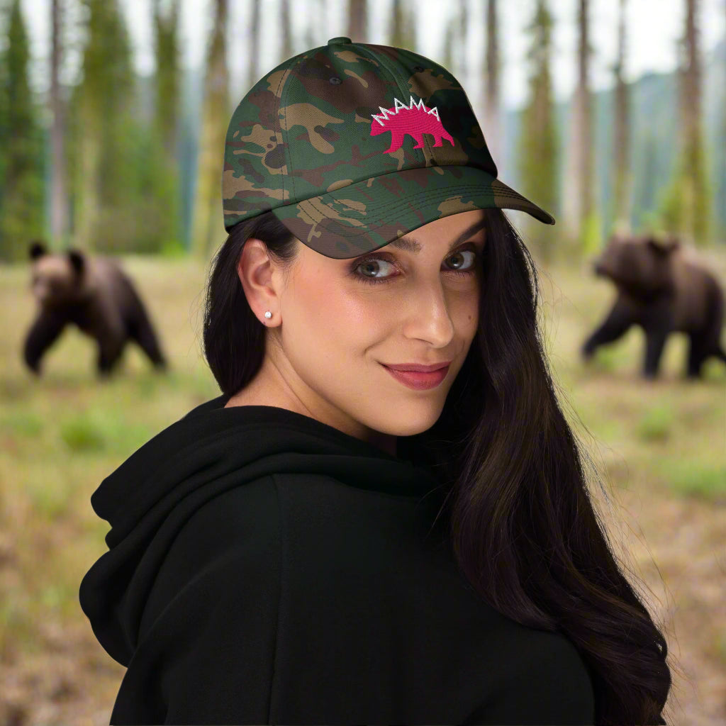Show your fierce, protective spirit with this stylish camo hat featuring the word "Mama" embroidered over a flamingo pink colored bear, which sends the message that you are a fierce mama bear. This design is a bold celebration of women’s empowerment and the strength of those who nurture, protect, and lead both at home and in the workplace.