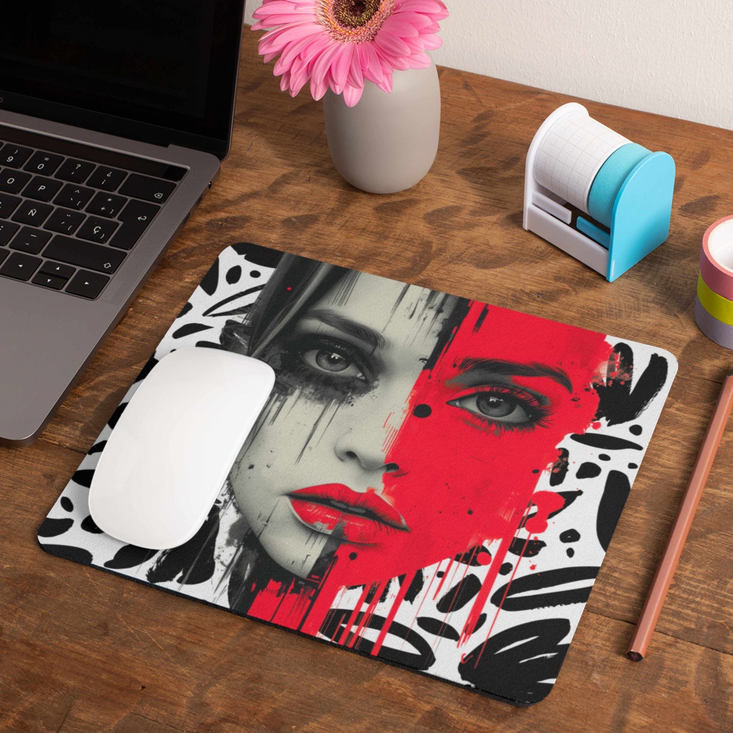 This mouse pad features a striking design of a woman's face, with one half in bold, outrageous red, framed by a collection of black and white shapes.