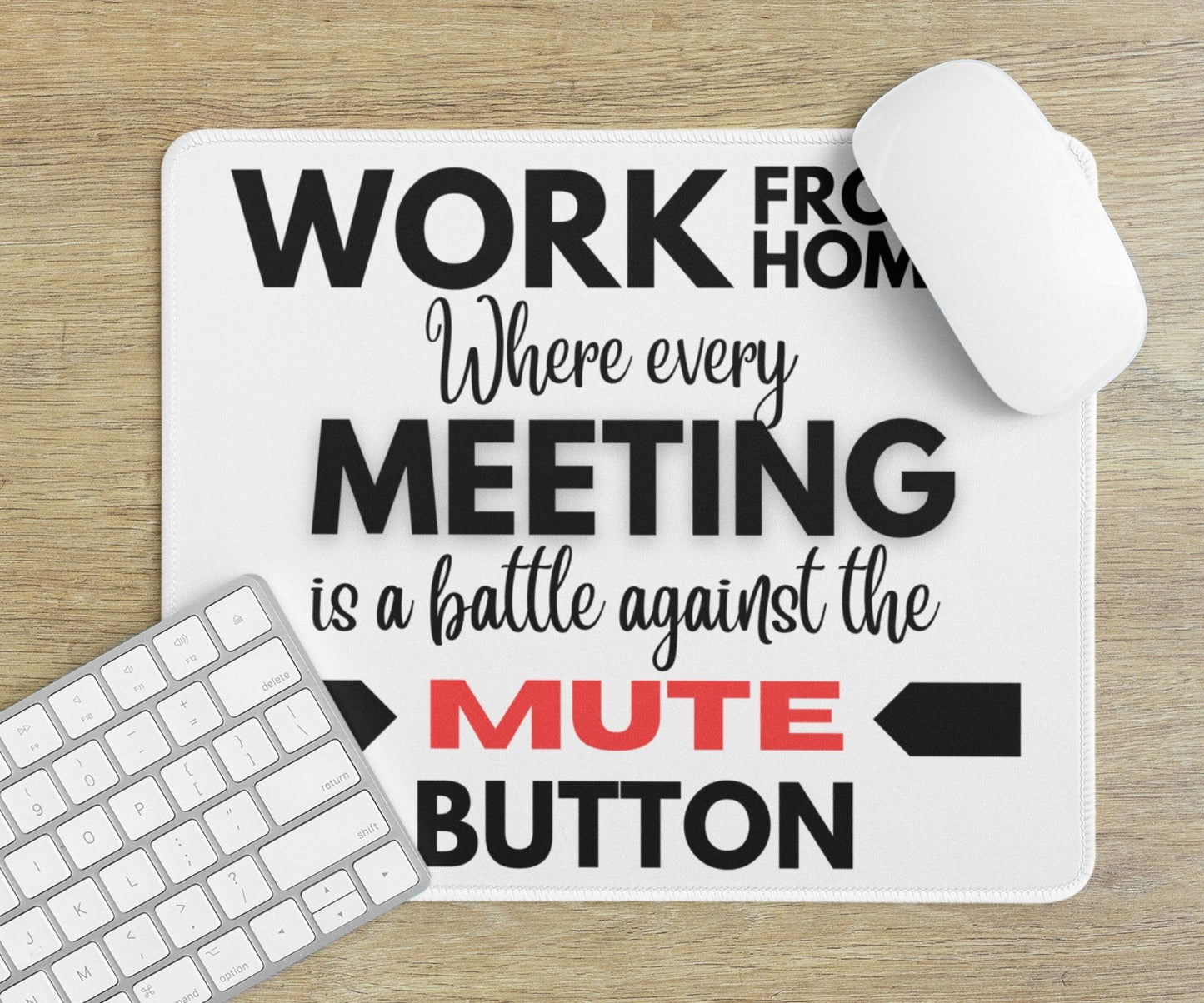 White mouse pad with the words "work from home: where every meeting is a battle against the mute button." The word MUTE is in a bold red color emphasizing the struggle against going off mute.