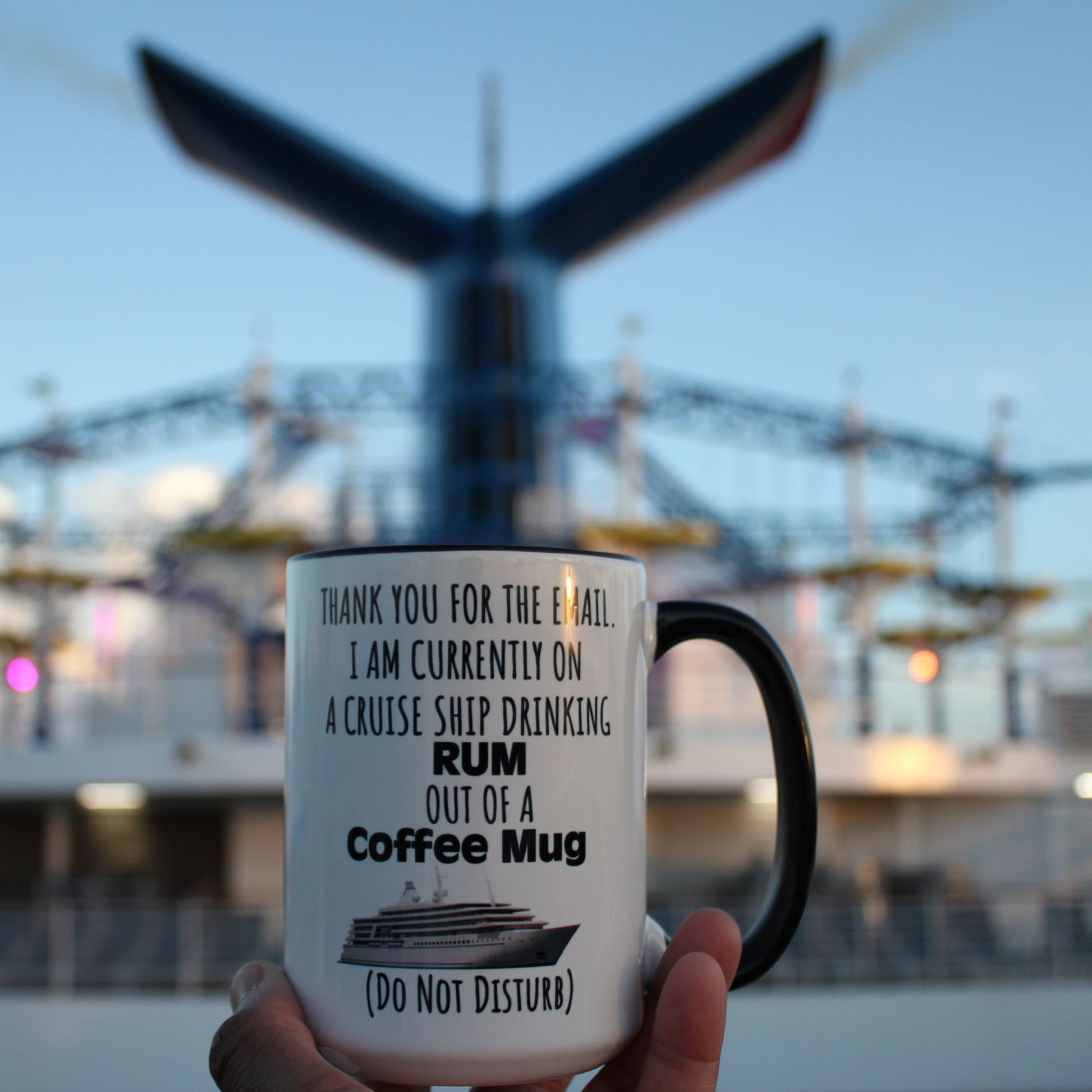 Embrace the ultimate out-of-office experience with our "Thank You for the Email. I Am Currently on a Cruise Ship Drinking Rum Out of a Coffee Mug" mug. Imagine sitting at a bar on a carnival cruise sipping your favorite beverage in one of these mugs. You might get a few double takes, but it will surely be a conversation starter.